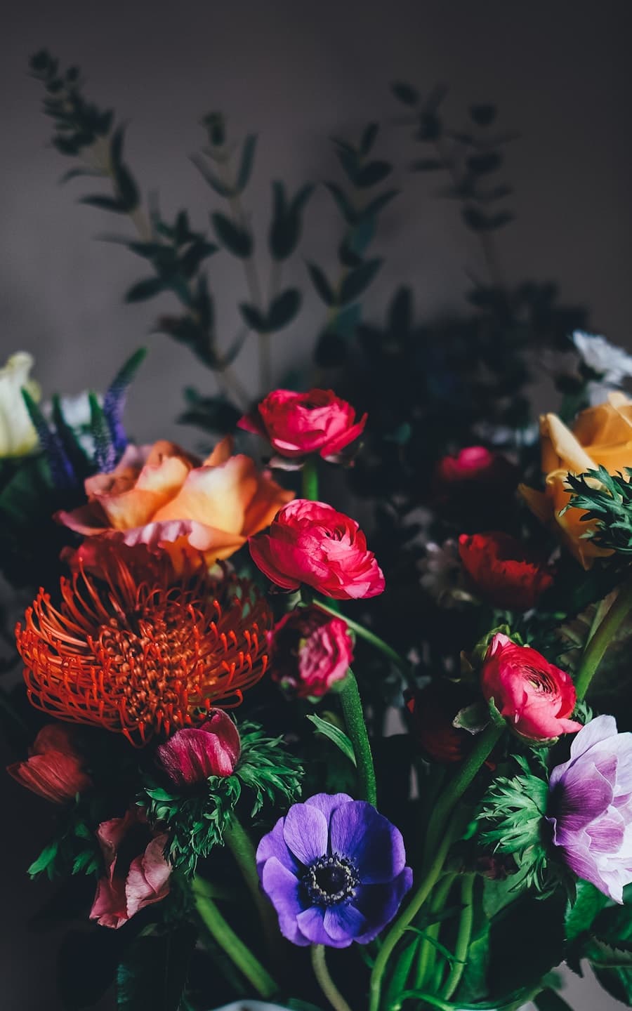 A florist arranging a colourful bouquet inside a flower shop